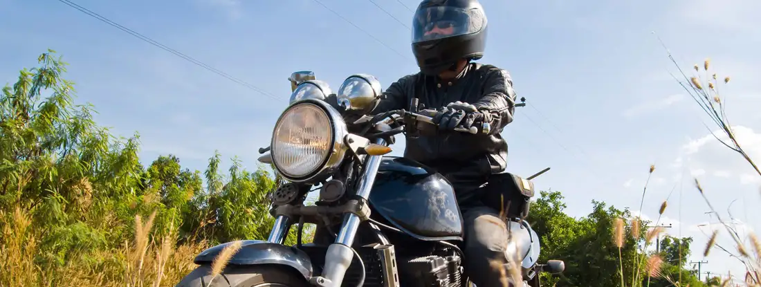 Motorcyclist on asphalt country road. Find Illinois Motorcycle Insurance.