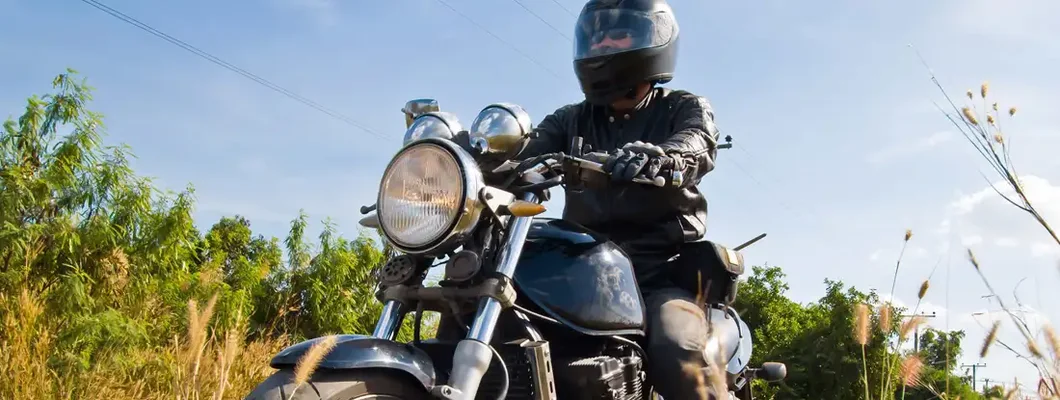 Motorcyclist on asphalt country road. Find Illinois Motorcycle Insurance.