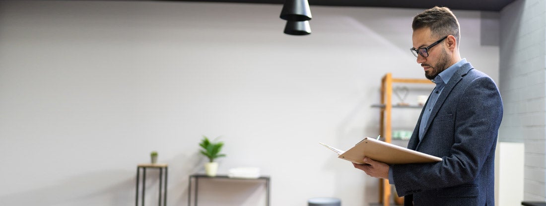 Landlord looking over rental application. Find West Virginia landlord insurance.