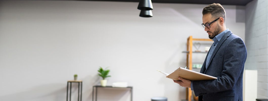 Landlord looking over rental application. Find West Virginia landlord insurance.