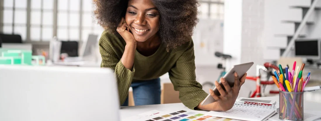 Woman working at a modern desk with various office supplies. Find Arizona Errors and Omissions Insurance.