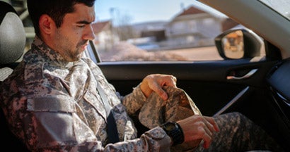 Soldier in a car coming home. Military Discounts for New Cars.