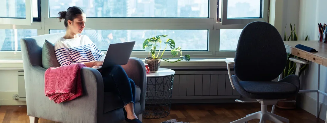 Woman working from home. How Much Does Renters Insurance Do I Need in 2026?