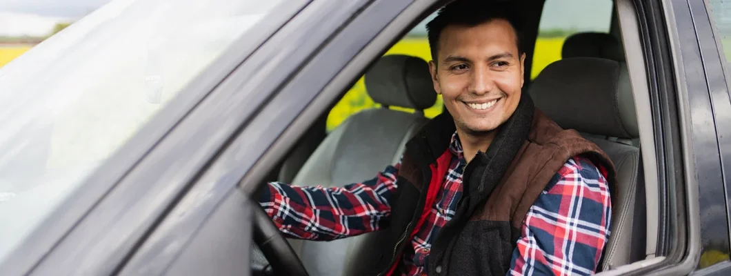 Young farmer sitting in an off road SUV vehicle. Southlake, Texas Car Insurance. 