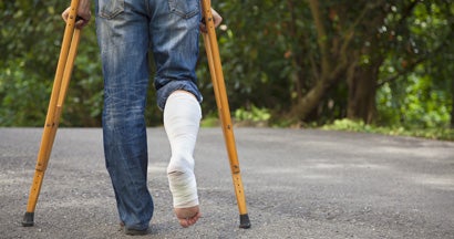Person using crutches due to a leg injury. Find disability income insurance.
