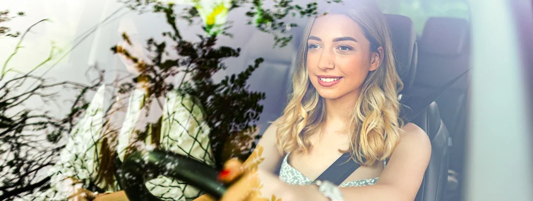 Friends driving car through the city. Find Teenage Car Insurance.