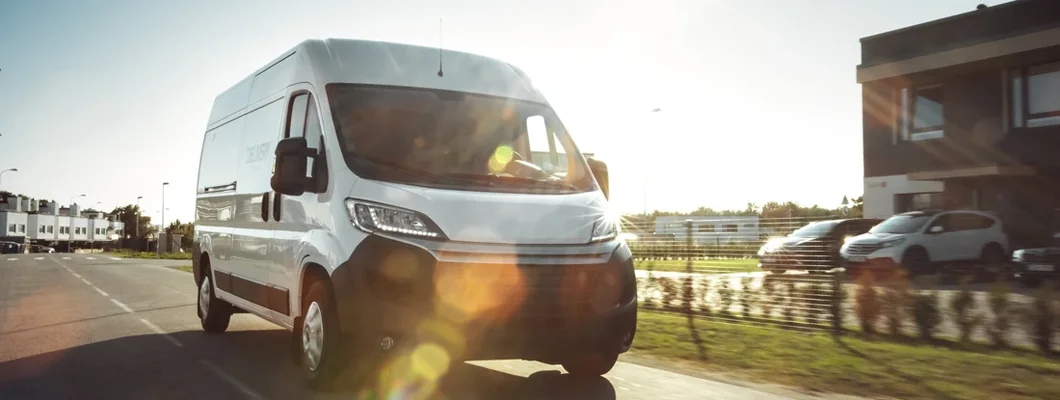 Delivery Van Driving Through the Beautiful Suburban Town Area. Find Nevada Commercial Vehicle Insurance.