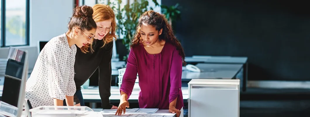Group of designers looking at blueprints in an office. How to Find the Best Business Insurance in West Linn, Oregon. 