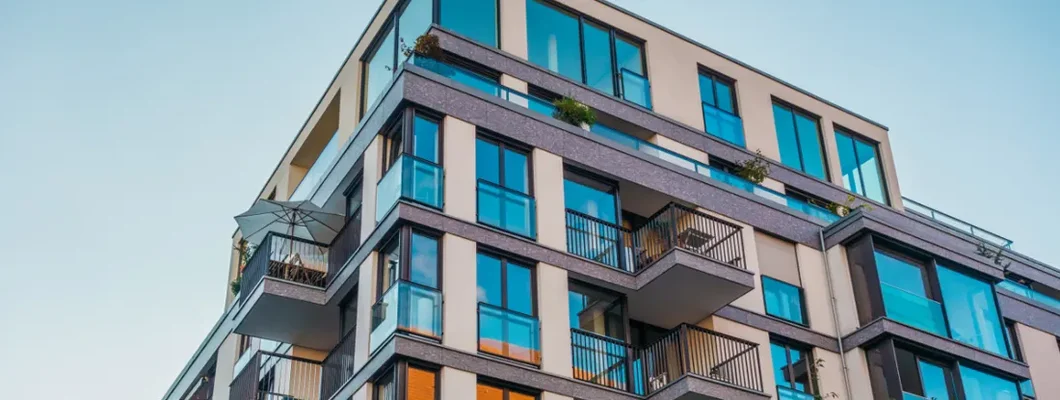 Modern corner apartment complex with blue colored windows. Find Ohio Condo Insurance. 