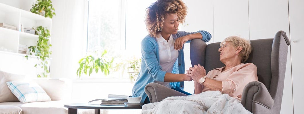 Home nurse taking care of an eldery lady. Traditional Long Term Care Insurance Coverages.