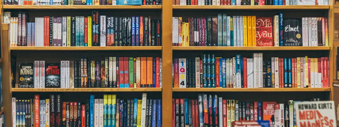 Books on shelves in a bookstore. Find bookstore insurance.