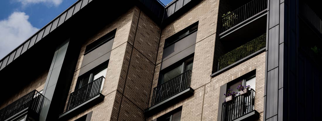 Modern brick apartment building exterior. Find New Hampshire renters insurance.
