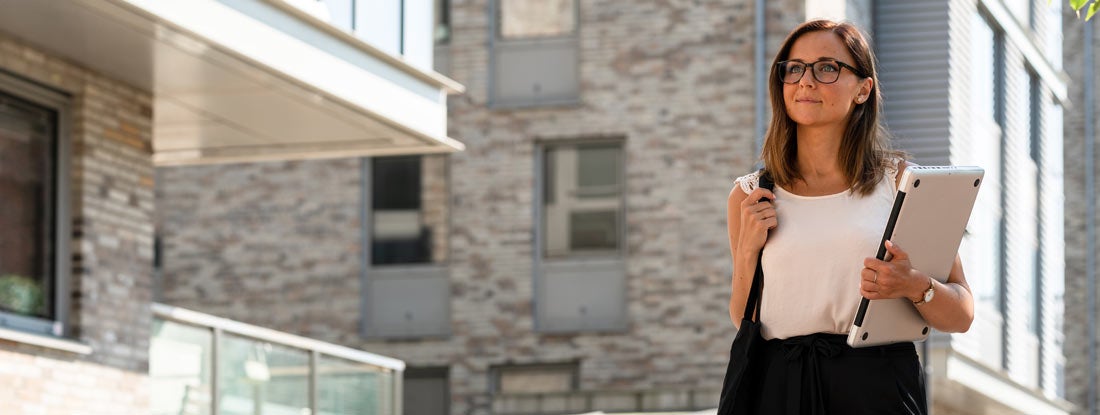 Woman with a laptop is working on the go. Find Arkansas landlord insurance.