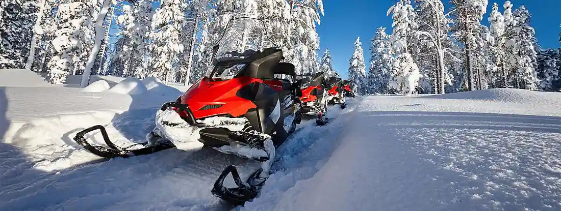 Group of red snowmobiles. Find Snowmobile Insurance.