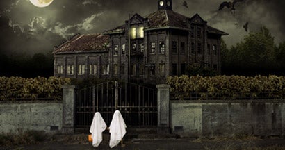 Children in Ghost Costumes Trick or Treat at Haunted House