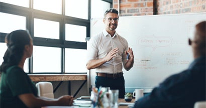 Business Consultant giving a presentation to a new business in boardroom