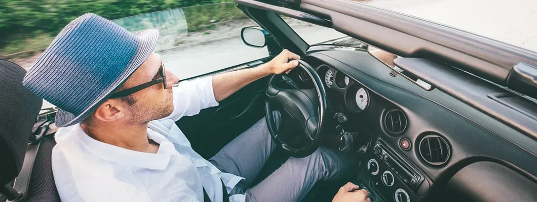 Man driving convertible car top view. How to Find the Best Car Insurance in Chalco, NE.