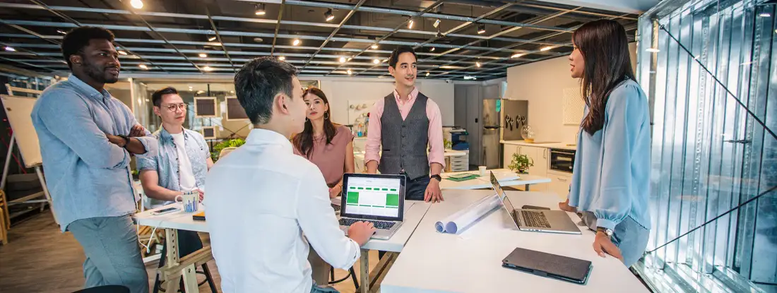 Young multi ethnic-group of people working in modern office. Find Media Liability Insurance.