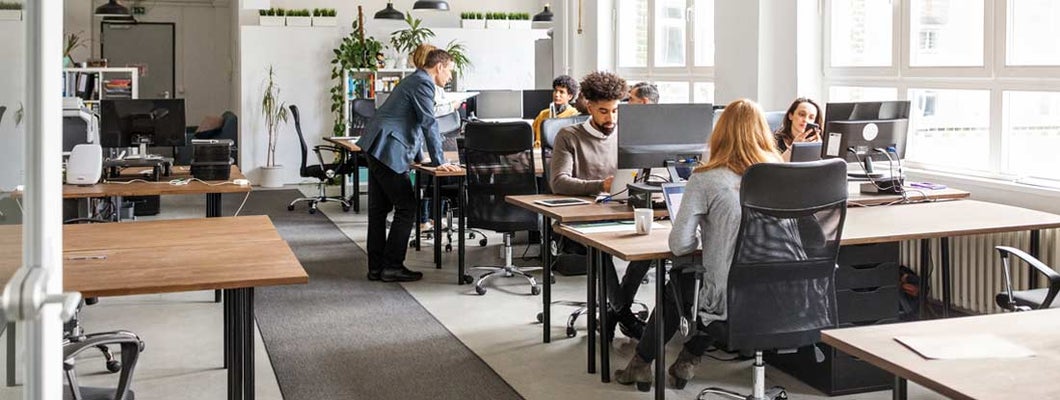 Business people working in modern office space. Voluntary disability insurance.