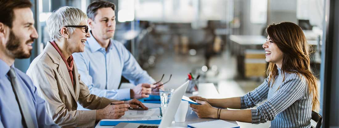Business team talking to their candidate on a job interview in the office. Find Temporary Staffing Insurance.