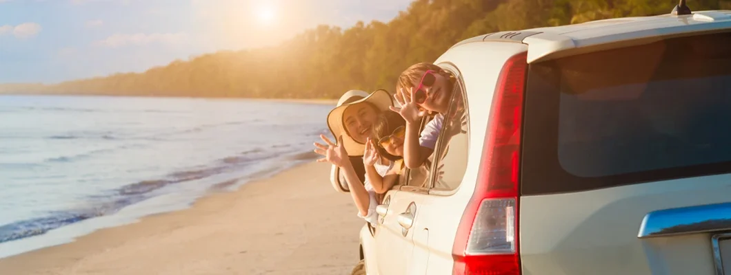 Family having fun together on the beach in summer holiday vacation. Why Is Car Insurance So Expensive in Florida?