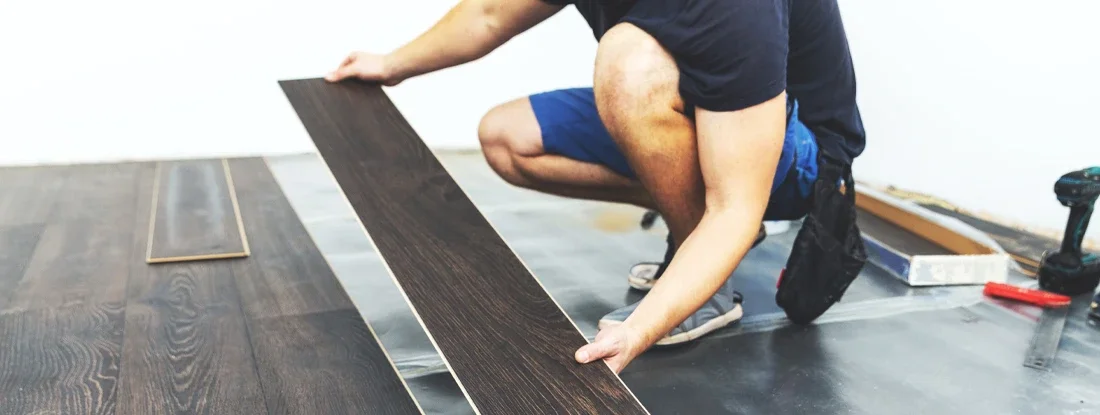 Worker installing new floor. Flooring Contractor Insurance.