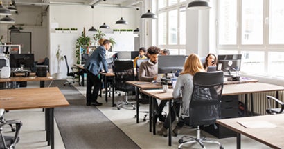 Business people working in modern office space. Voluntary disability insurance.