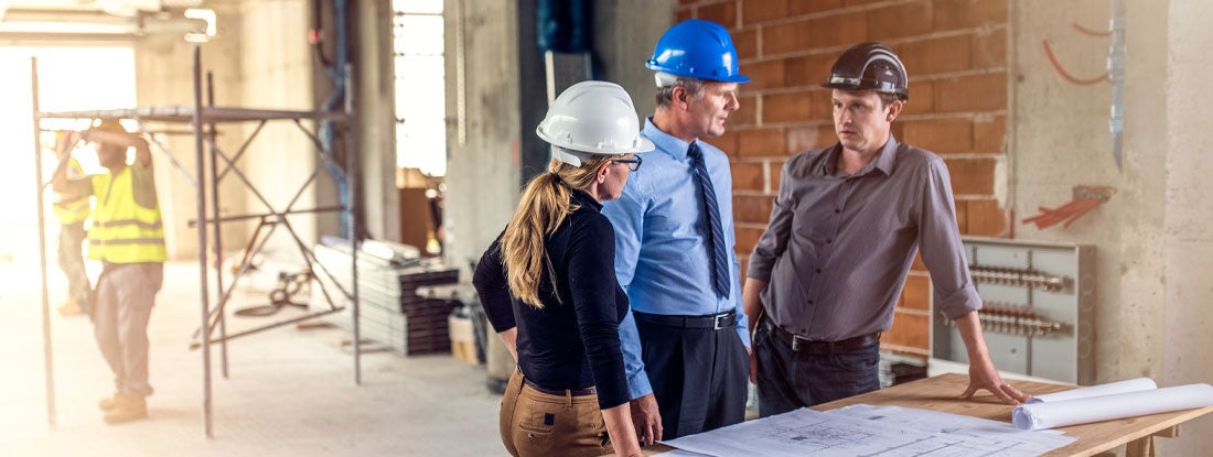 Construction workers and architects working on construction site. Find Errors and Omissions Insurance.