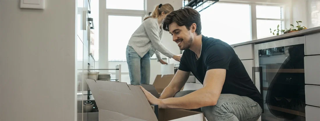 Man unpacking with girlfriend at new apartment. Does Renters Insurance Cover Moving in 2026?