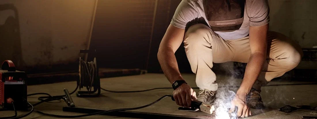Young welder working in his workshop. Find Welding Contractor Insurance.