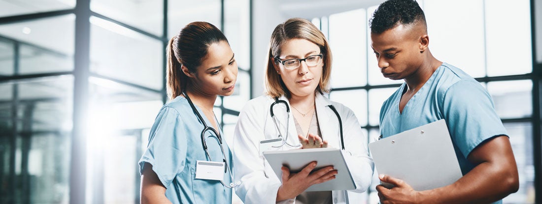 Doctors looking over medical records. Massachusetts Medical Malpractice Insurance