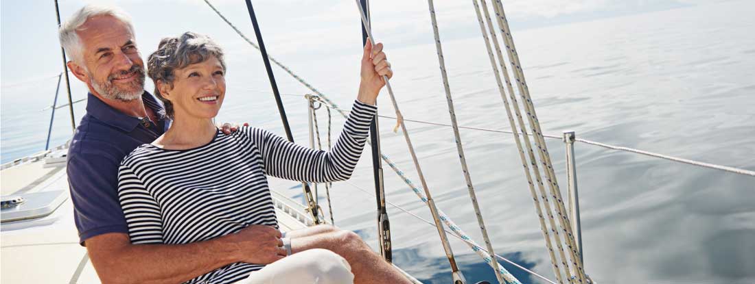 Happy senior couple enjoying a sail boat. Fixed Annuity Companies.
