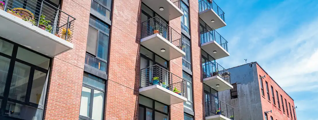 Brick, low rise, condos on a sunny day. Find Montana Condo Insurance.