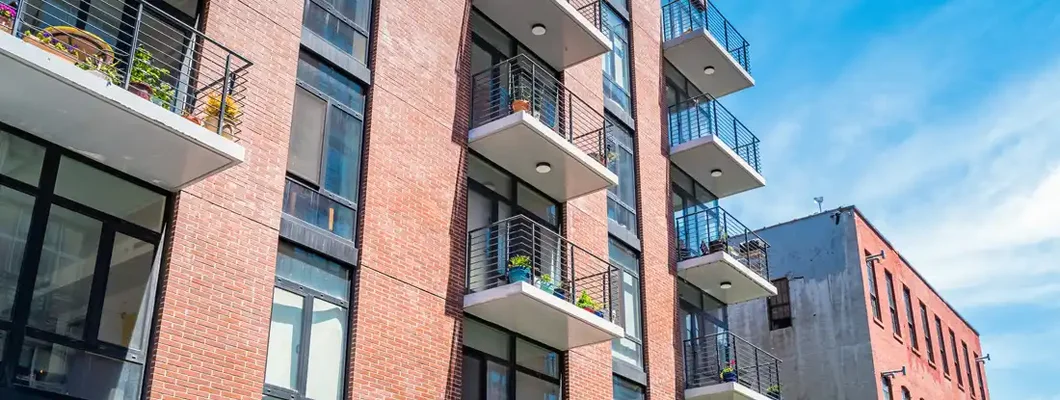 Brick, low rise, condos on a sunny day. Find Montana Condo Insurance.