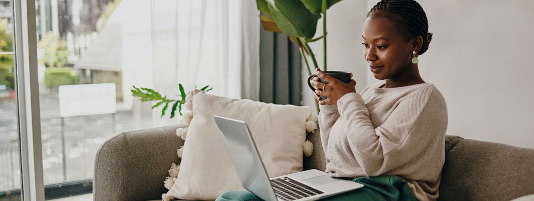 Woman having coffee and shopping online for insurance. Which is better, an independent agent or an online bot?