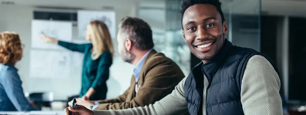 Young businessman sitting in conference room. Find Stamford, Connecticut business insurance.