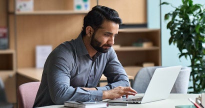 Man working on laptop at home office. Compare Landlord Insurance.