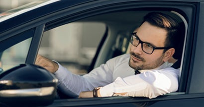 Man driving car. Find Non Owner Car Insurance.