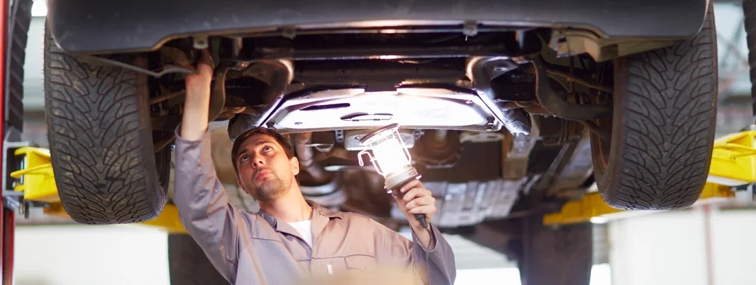 Car mechanic at work in repair garage. Does Car Insurance Cover Repairs in 2026?