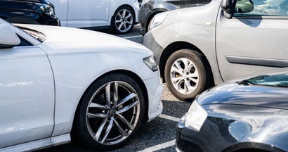 Parked cars in used car lot. Can you really get an SUV for $20,000 or less? 