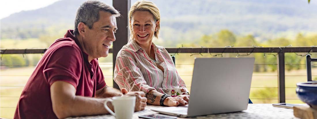 Couple Using a Computer at their Farm. The Complete Guide to Annuity Values.