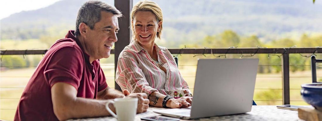 Couple Using a Computer at their Farm. The Complete Guide to Annuity Values.
