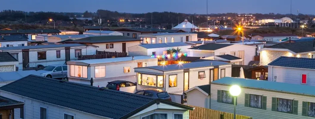 Mobile homes on a trailer park at dusk. Find Mobile Home Park Insurance.