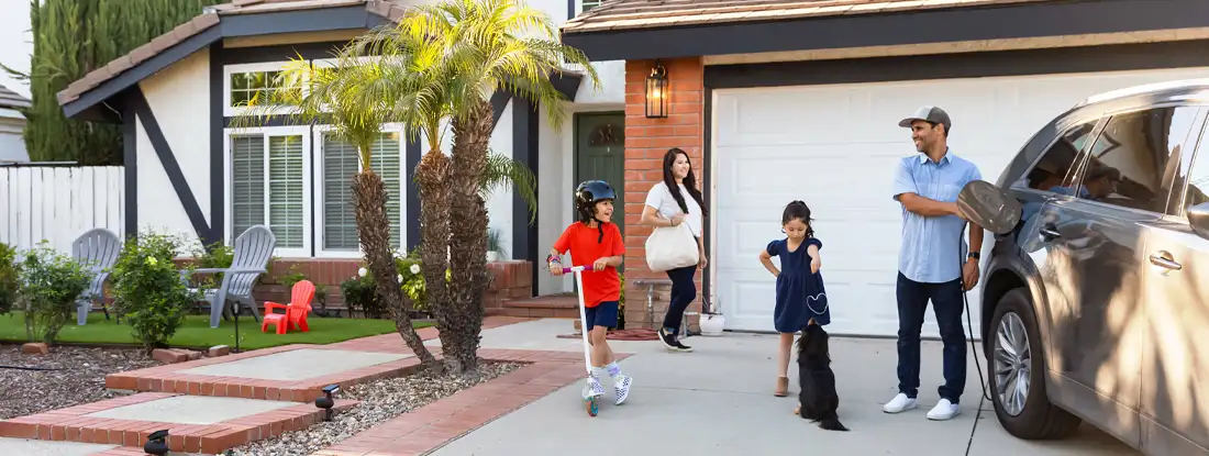 Family with electric vehicle. Compare Umbrella Insurance.