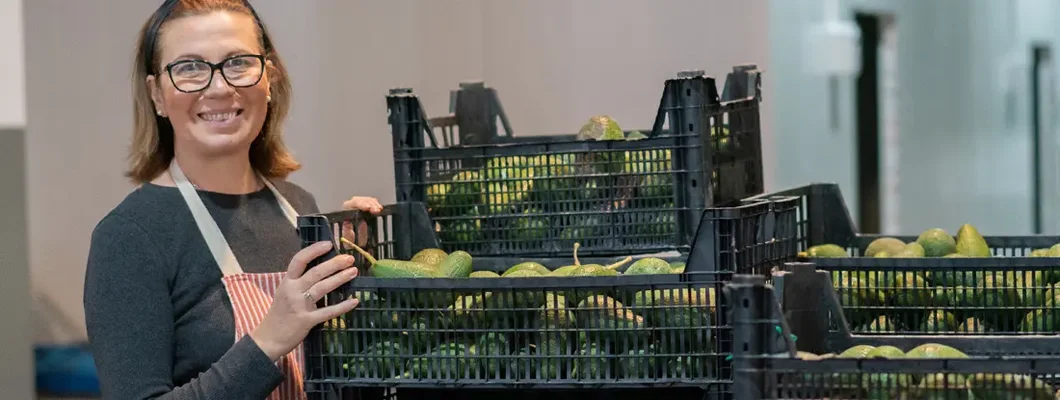 Worker preparing to pack fruit at warehouse. Find Prairie Village, Kansas business insurance.