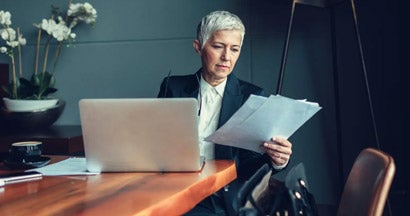 Mature Businesswoman In Her Office. What is Errors and Omissions Insurance?