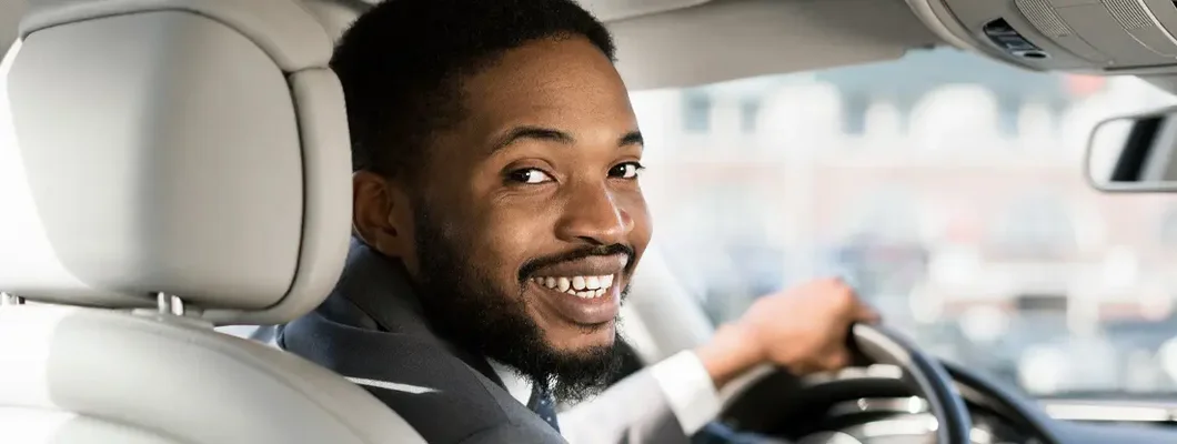 Driver Looking At Camera Sitting In Car . Find Union, Kentucky car insurance.