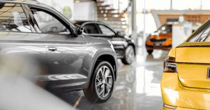 Cars parked in luxury showroom. Hybrid vs. Gas-Powered Cars: Which is Best?