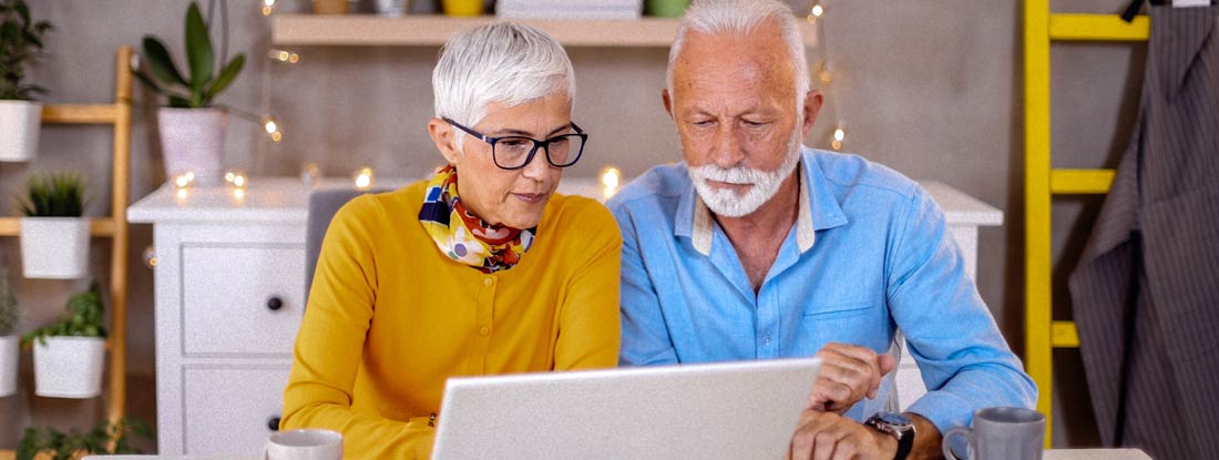Senior couple using a laptop together at home. Who Regulates Variable Annuities?