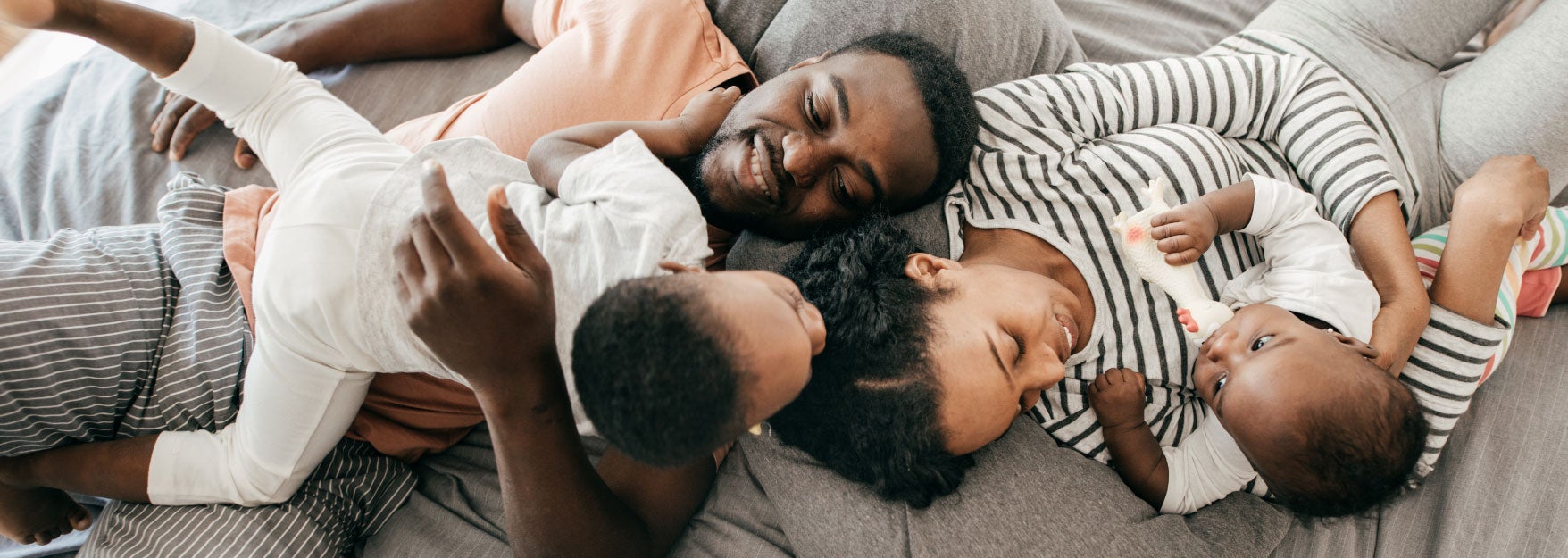 Family lying down on bed